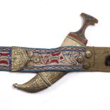 A Qajar Jambiya dagger with embroidered belt and gilt metal mounts, the scabbard with Koranic