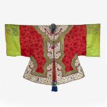 A Chinese red silk robe 19th Century with ruyi white ground shaped collar and borders, with green
