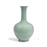 A Chinese porcelain bottle vase Guangxu (1875-1908) decorated with a pale green monochrome glaze,