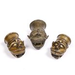 Three Indian Brass palanquin finials each depicting a tigers face, to include a pair and one