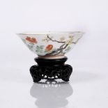 A Chinese porcelain shallow broad rimmed bowl decorated in famille rose enamels with flowering