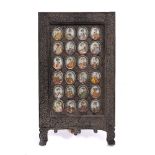 Indian School 19th Century set of twenty four oval miniature Mughal portraits, each on ivory, in a