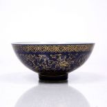 A Chinese porcelain bowl 19th Century decorated with a dark blue glaze over painted in gilt with