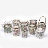 A collection of nine Chinese Canton teapots each of cylindrical form, various sizes, largest 17cm