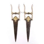 A pair of Indian push daggers 18th Century each with engraved brass handles and steel blade