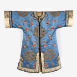 A Chinese Peking knot blue robe 19th Century with embroidered roundels of flower sprays with white