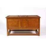 Cotswold School Oak coffer, circa 1940 hinged lid, panelled front, all raised on square cut supports