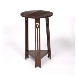 Liberty & Co. Oak occasional table, circa 1900 circular top over three pierced legs united by