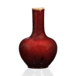 A Chinese sang de boeuf bottle vase 19th Century the faintly striated glaze fading to a darker hue