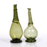 Two Persian green glass vases 18th century each finished with a glass spiral to the neck, 26cmm