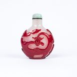 A Chinese Beijing overlaid glass bottle 1840-1885 of rounded pilgrim flask form, decorated in ruby