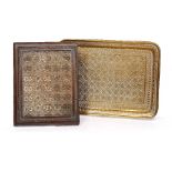 Two Persian metal trays each engraved with repeating patterns of geometric and foliate design,