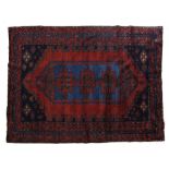 A Caucasian red ground rug with blue geometric medallions, 205cm x 149cm