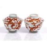 A pair of Chinese rice bowls and covers Guangxu each with iron-red decorated dragons and flaming