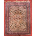 A PERSIAN ISFAHAN CARPET with an all over pattern of scrolling flowers and foliate on a white ground