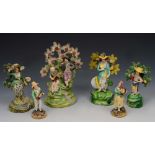 AN EARLY STAFFORDSHIRE POTTERY GROUP of musicians in a bocage titled 'Village Group', 22cm h; and