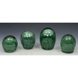 A GROUP OF FOUR GREEN GLASS DUMPY PAPERWEIGHTS with varying foliate decoration, 13cm to 9cm h (4)