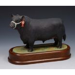 A ROYAL WORCESTER MODEL of an Aberdeen-Angus Bull by Doris Lindner 1961, 23cm lg on wooden stand