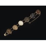 A LAVA CAMEO BRACELET AND A CAMEO PENDANT, the bracelet set with six vari-coloured oval lava cameos,