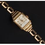 A LADY'S BRACELET WATCH, the square silvered dial with alternate Arabic numerals and square bead