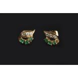 A PAIR OF EMERALD AND DIAMOND EARSTUDS, each pierced foliate panel highlighted with trios of