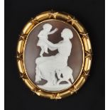 A 19TH CENTURY SHELL CAMEO BROOCH, the oval cameo carved to depict a mother and child seated on a