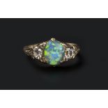 AN OPAL AND DIAMOND DRESS RING, the oval cabochon opal claw set between two cushion-shaped diamonds,