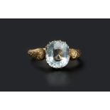 A RUSSIAN AQUAMARINE SINGLE STONE RING, the cushion-shaped mixed-cut aquamarine in claw setting,