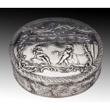 A GERMAN SNUFF BOX, oval shaped and chased with scenes of children at play, 7.5cm long, stamped 800,