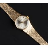 A LADY'S 9CT GOLD BRACELET WATCH BY AVIA, the circular signed silvered dial with baton markers, to a