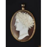 A VICTORIAN SHELL CAMEO PENDANT, the oval shell cameo carved to depict the profile of Demetre, the