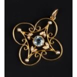 AN EARLY 20TH CENTURY GEM SET PENDANT, the openwork quatrefoil-shaped panel centred with a