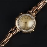 A LADY'S DIAMOND SET WRISTWATCH, the circular dial with Arabic numerals and outer minute scale,