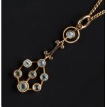 A GEM SET PENDANT NECKLACE, the openwork panel drop highlighted with graduated circular-cut blue