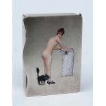 AN UNMARKED METAL SERPENTINE VESTA CASE with enamelled nude female figure decoration, 5 x 3.2cm