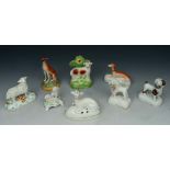 A GROUP OF EIGHT STAFFORDSHIRE POLYCHROME POTTERY MODELS of dogs/deer/sheep, 11cm high and smaller