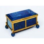 A FRENCH LAPIS LAZULI AND GILT METAL MOUNTED RECTANGULAR MINIATURE CASKET on ball feet, 7.5cm wide