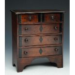 AN APPRENTICE MINIATURE MAHOGANY CHEST of two short and three long drawers with inlaid decoration,