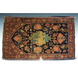 AN OLD PERSIAN BLUE GROUND MAT with central architectural motif within a foliate ground (tears),