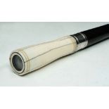 AN EBONY WALKING STICK with ivory 'eye' handle and silver metal ferrule, 90.2cm long