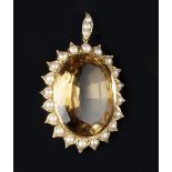 A CITRINE AND HALF PEARL CLUSTER PENDANT, the oval mixed-cut citrine framed by a foliate border of