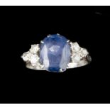 A SAPPHIRE AND DIAMOND DRESS RING, the oval mixed-cut sapphire claw set between trios of old-cut