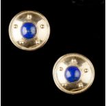 A PAIR OF LAPIS LAZULI EARSTUDS, each circular convex panel centred with a lapis lazuli cabochon,