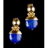 A PAIR OF LAPIS LAZULI EAR PENDANTS, each circular lapis lazuli drop suspended from a stylised