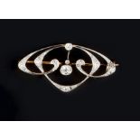 AN ART NOUVEAU DIAMOND SET BROOCH, the openwork sinuous panel centred with an old brilliant-cut