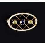A GEM SET AND ENAMEL PANEL BROOCH, of oval lattice work design, centred with an oval mixed-cut