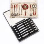 A NORWEGIAN SILVER AND RED ENAMEL SET of six teaspoons, tea strainer and sugar tongs, cased; and a