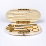 A FRENCH GILT METAL AND STEEL SEWING ETUI fitted scissors, needle case, thimble and three further