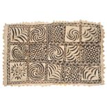 A POLYNESIAN TAPA CLOTH with stylized geometric and foliate panels in hooked border, signed, approx.