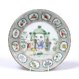 AN 18TH CENTURY CHINESE PORCELAIN PLATE decorated figures under an archway in polychrome enamels,